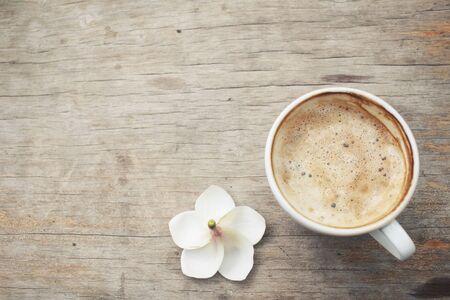Coffee with milk and white frangipani flowerの写真素材