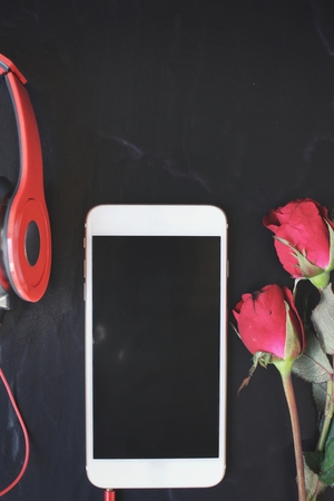 Red rose with earphone and smart phoneの写真素材