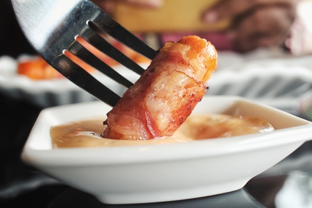 Sausage wrapped in baconの写真素材