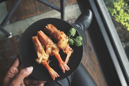 Selfie of fried shrimps with handの写真素材