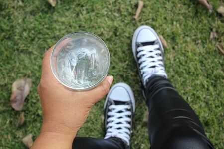 Selfie of water drink with handの写真素材
