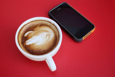Latte art coffee with smart phoneの写真素材