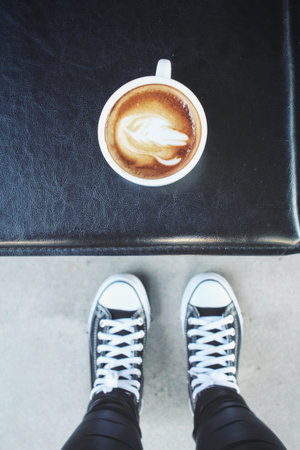 Selfie of shoes with coffee cup