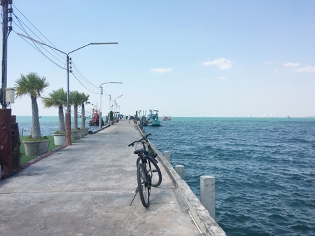 Bicycle on bridge at the seaの写真素材