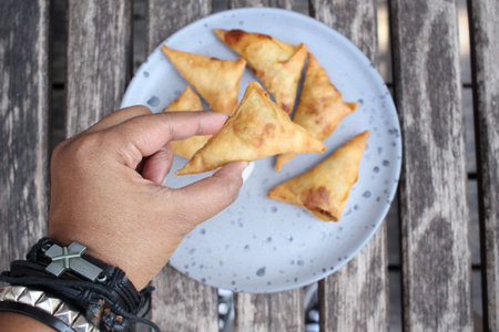 Selfie of samosa with hand