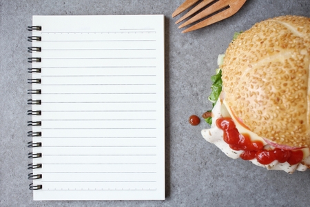 Hamburger with blank notepadの写真素材