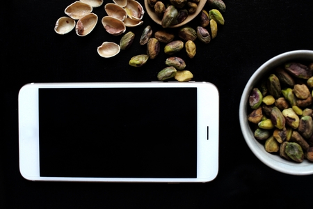 Pistachio with smart phoneの写真素材