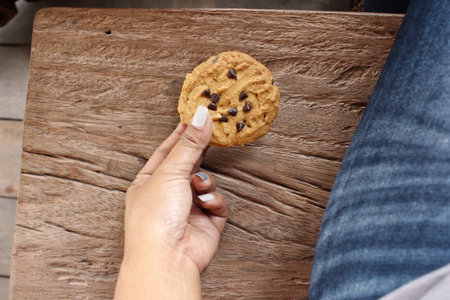Woman eating cookie chocolateの写真素材