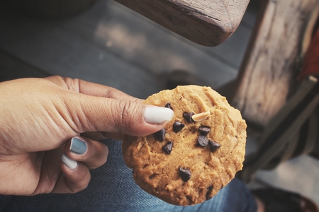 Woman eating cookie chocolateの写真素材