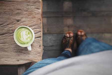 Woman drinking green tea and milkの写真素材