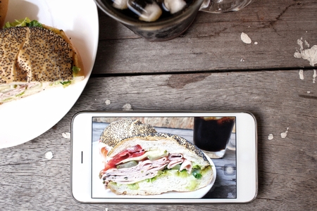 Taking a photo of hamburger with smart phoneの写真素材