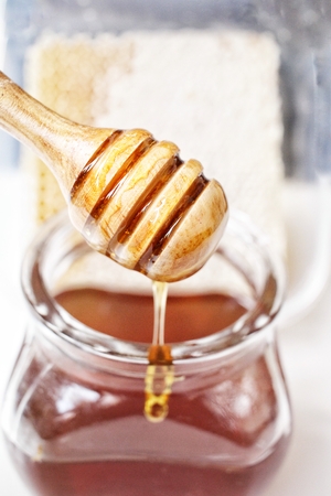 Fresh honey with honey dipperの写真素材