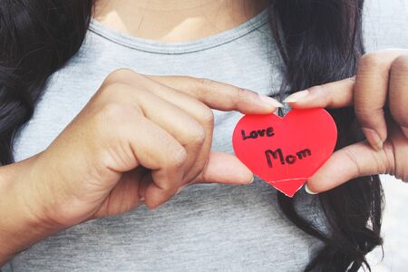 Woman with heart mom on handの写真素材