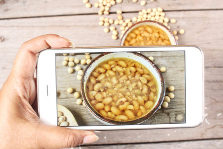 Taking a photo of salted soy beans with smart phone
