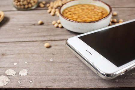 Salted soy beans with smart phoneの写真素材