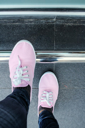 Legs of woman with sneakersの写真素材