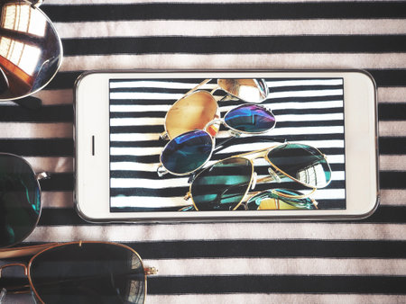 Taking a photo of with sun glasses smart phoneの写真素材