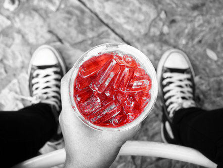 Selfie of iced tea on hand with shoes