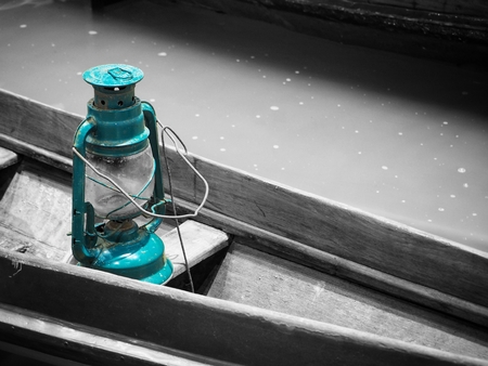 Vintage dirty oil lamp on wooden boatの写真素材