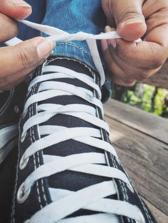 Woman tying sneakers lacesの写真素材