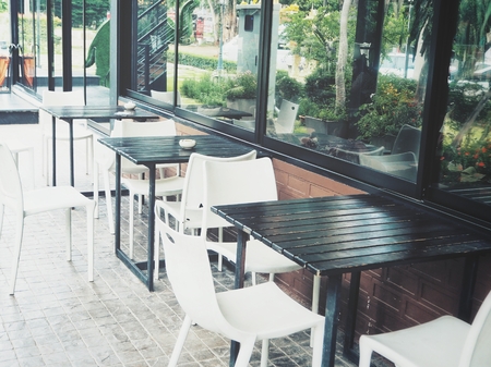 Table with chairs at restaurantの写真素材