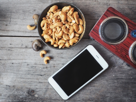 wireless speaker with smart phone and cashew nutsの写真素材