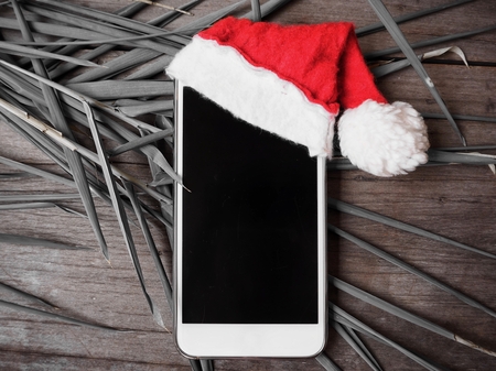 Smart phone with christmas hatの写真素材