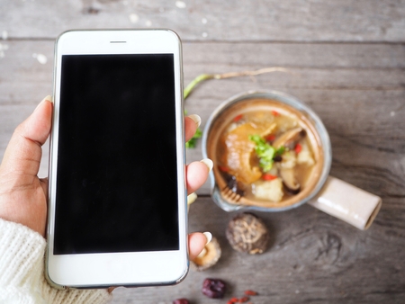 Chinese soup and shark fin with smart phoneの写真素材