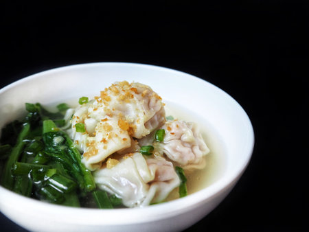 Wonton soup on black backgroundの写真素材