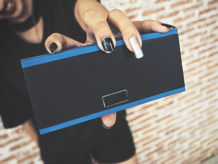 Woman using bluetooth speakerの写真素材