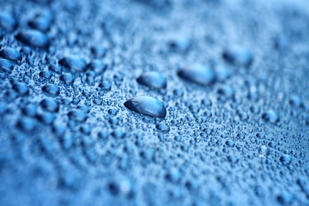 Water drop on blue backgroundの写真素材