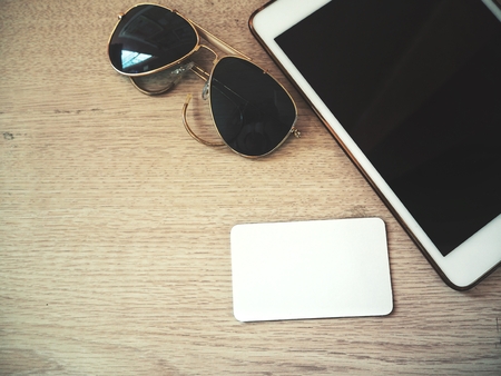 Blank card with sun glasses and tabletの写真素材