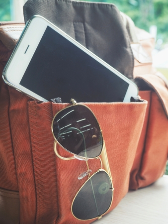 Smart phone with sun glasses and bagの写真素材