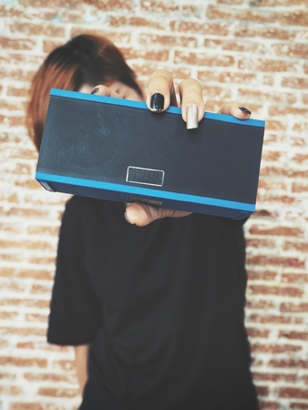 Woman using bluetooth speakerの写真素材