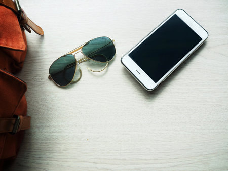 Smart phone with sun glasses and bagの写真素材