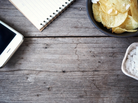 Potato chip with blank notepad and smart phoneの写真素材