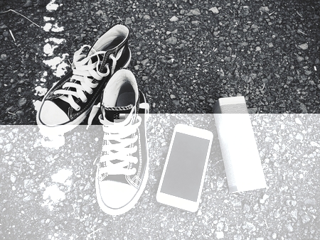 wireless speaker with smart phone and sneakers on streetの写真素材