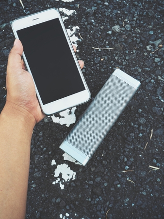 Woman using bluetooth speaker with smart phoneの写真素材