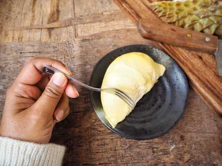 Woman eating durianの写真素材