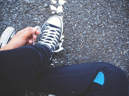 Woman tying sneakers lacesの写真素材