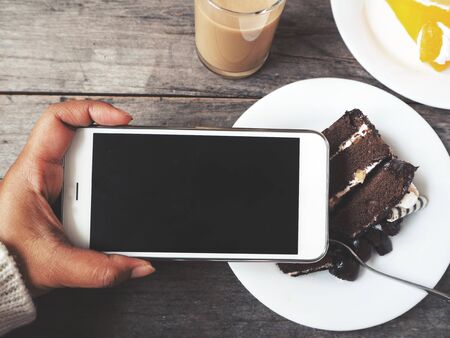 Chocolate cake with smart phoneの写真素材