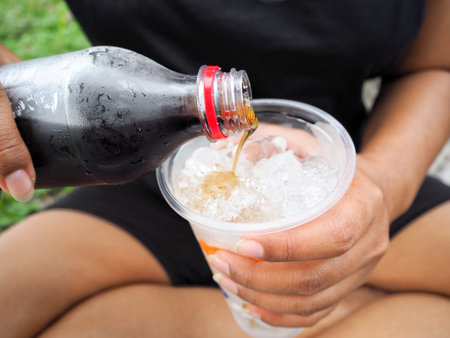 Woman pouring cola drink
