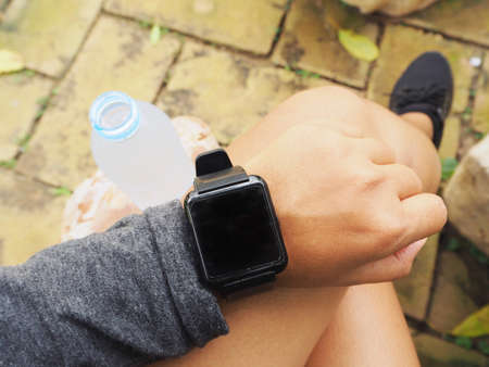 Selfie of smartwatch and sport shoes with water bottleの写真素材