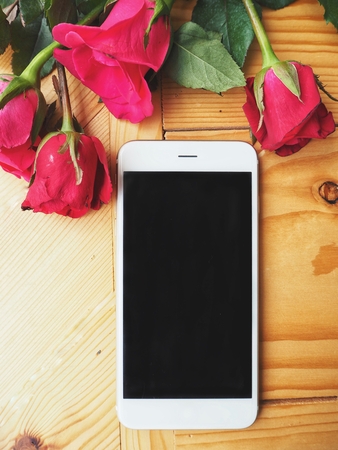 Smart phone with red rose in valentines dayの写真素材