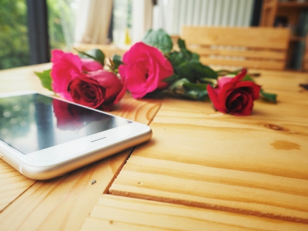 Smart phone with red rose in valentines dayの写真素材