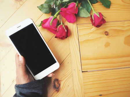 Smart phone with red rose in valentines dayの写真素材