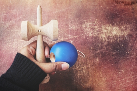 Woman playing kendama japanese toyの写真素材