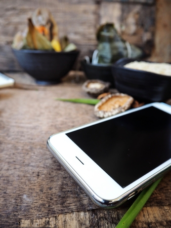 Zongzi chinese food with smart phoneの写真素材