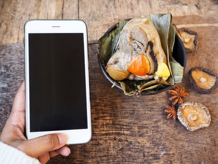 Zongzi chinese food with smart phoneの写真素材