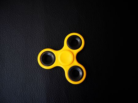 Fidget spinner on black backgroundの写真素材